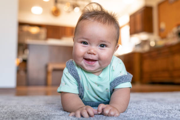 Baby lying on carpet flooring | Tom January Floors